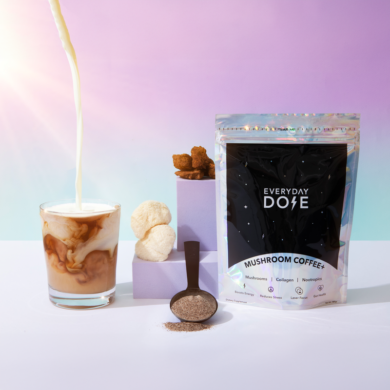Gift 1 Month of Everyday Dose mushroom coffee package with iced latte pour and ingredients on pastel background