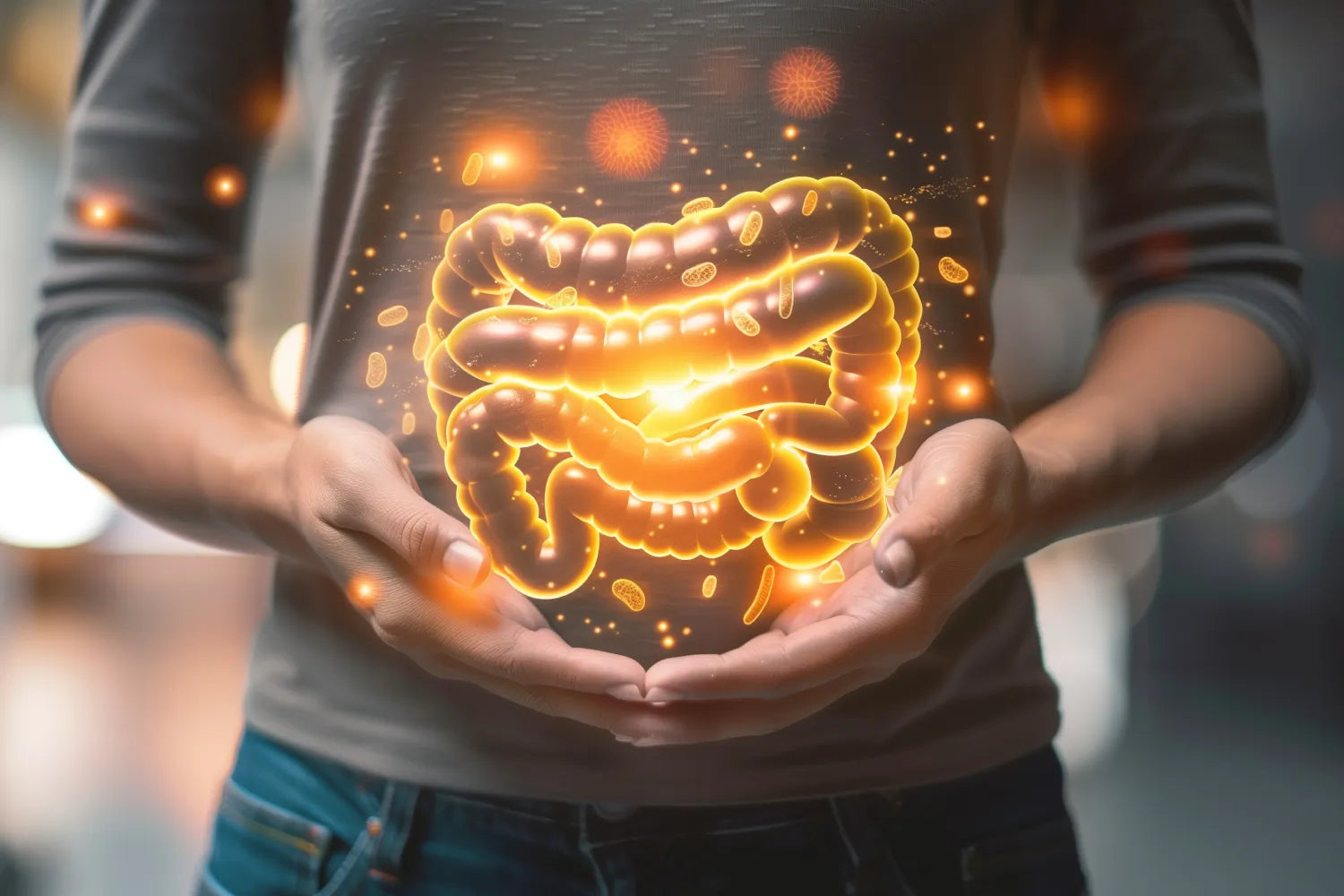 Person cupping a glowing holographic large intestine over their abdomen, surrounded by floating microbiome particles and warm orange light