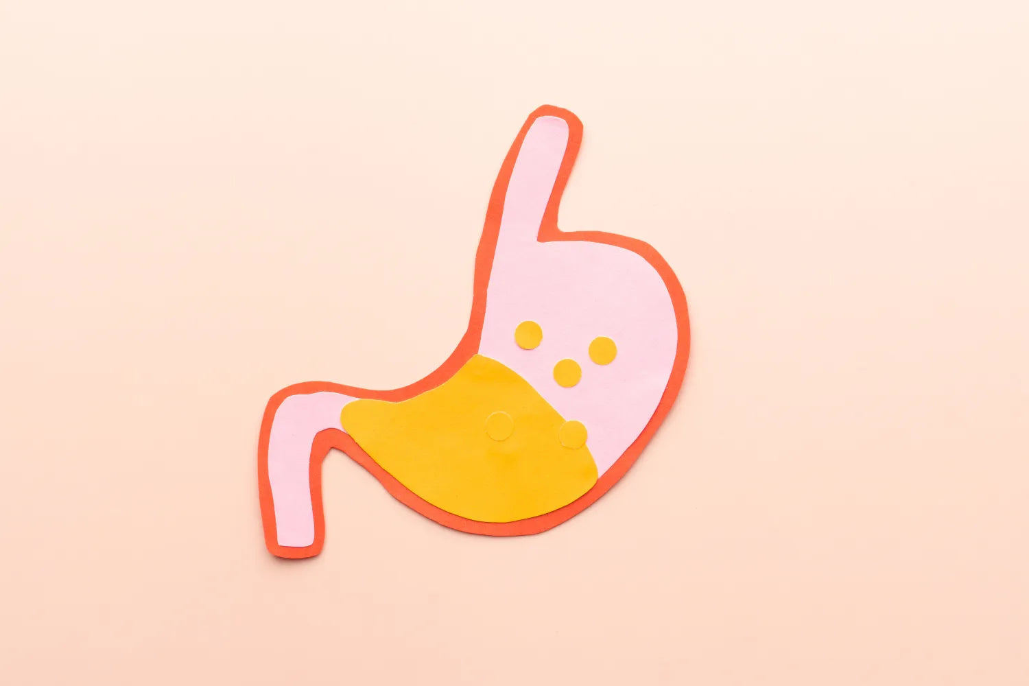 Stylized paper-cut illustration of a stomach with yellow gastric acid pooling to represent acid reflux
