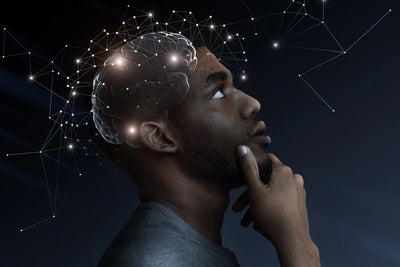 Man in profile looking upward thoughtfully with translucent brain and glowing neural network overlay on dark background