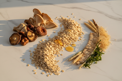 Rolled oats, dried shiitake and oyster mushrooms, wheat stalks, seaweed and honey drops on marble showing beta glucan sources