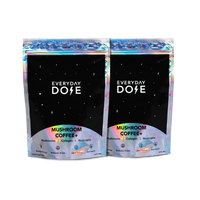 Two black holographic packages of 60-Servings Everyday Dose Mushroom Coffee Plus with iridescent trim and starry design
