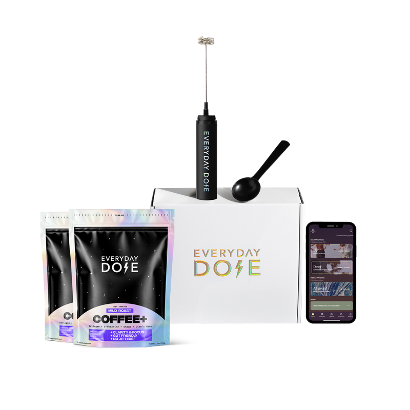 Front view of Everyday Dose Mushroom Coffee pouches and box with frother, scoop, and smartphone app on white background
