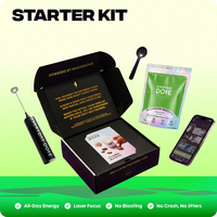 Open black box with mushroom powder pouch, black measuring spoon, black frother, informational card, and smartphone displaying app interface on green background