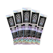 Angled view of five Everyday Dose Coffee+ Medium Roast stick packs showcasing dark packaging with colorful accents and a coffee bean illustration on a white background